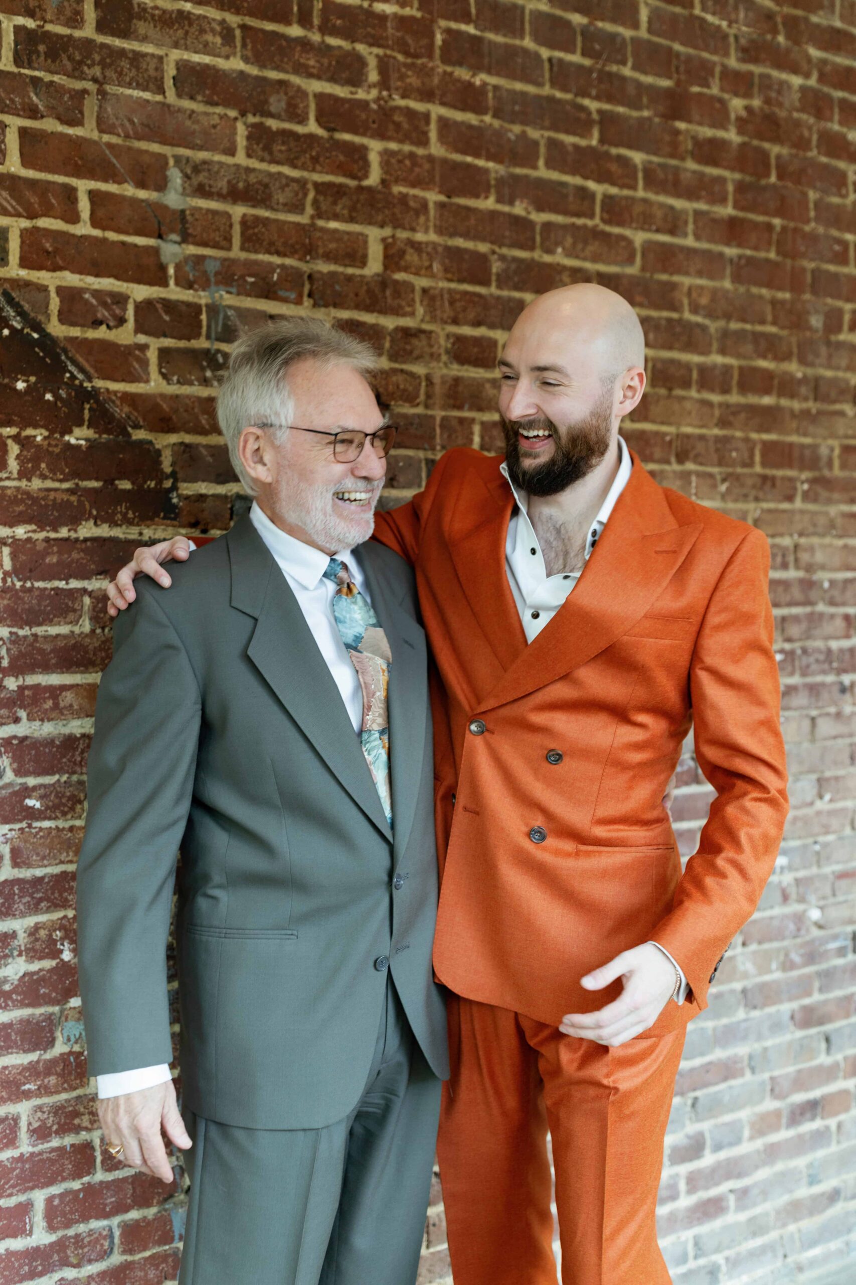 The groom laughing with his dad.