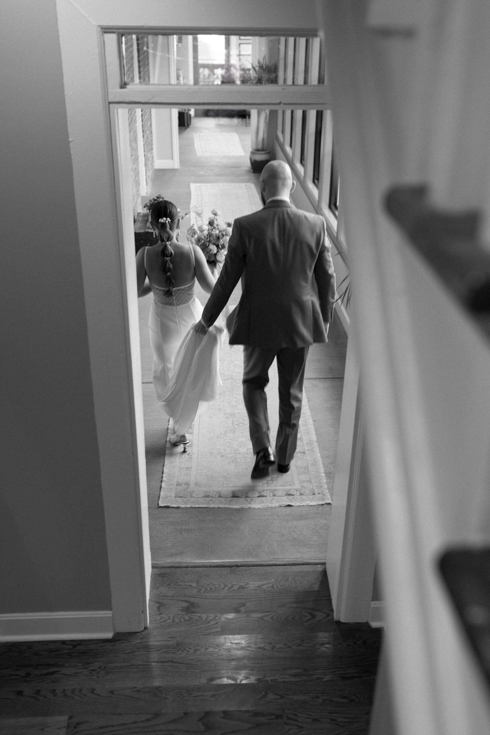 The couple walking away through a door.