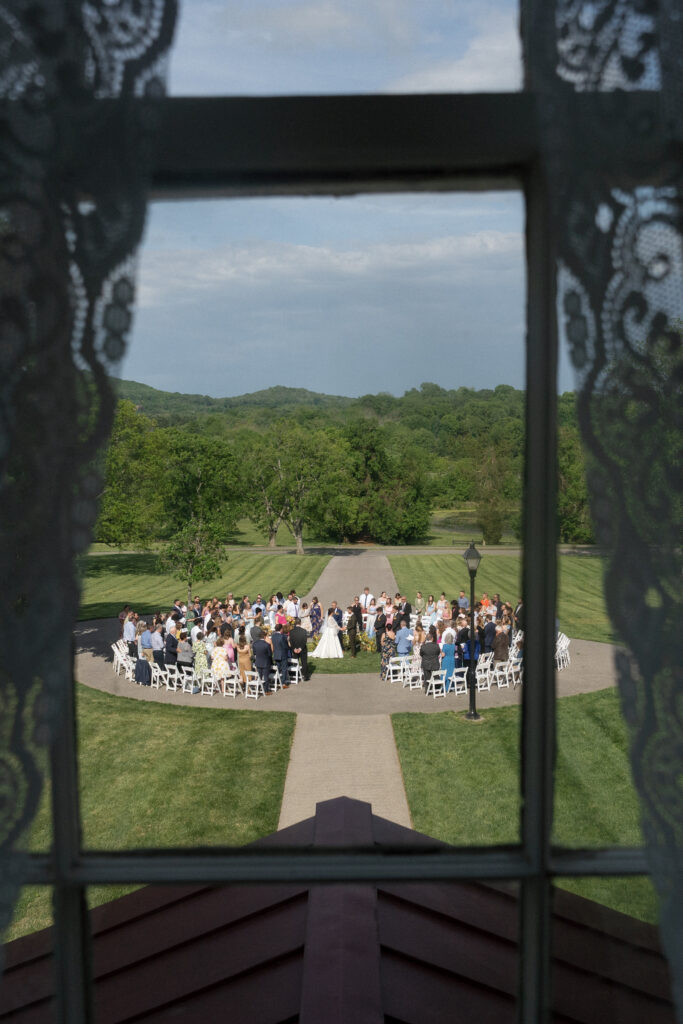 A photo of the ceremony through a window.