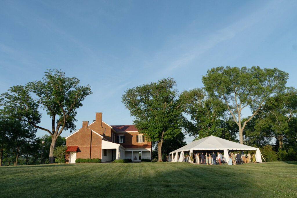 A wide shot of the tent and scene.