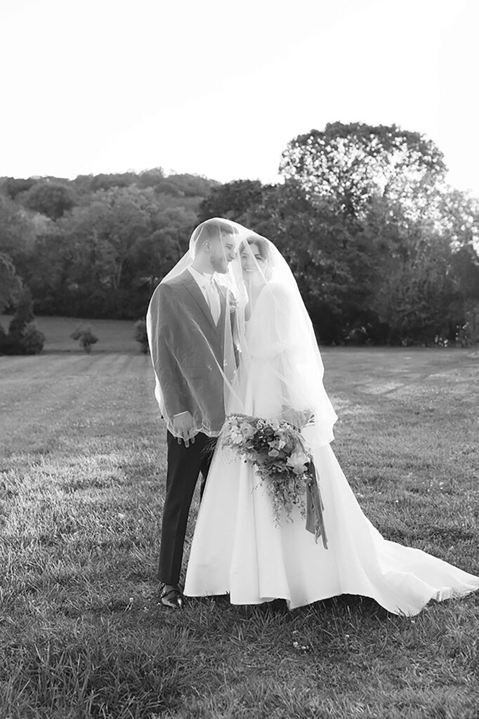 A classic portrait of the couple and the bride is laughing.